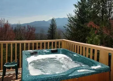 Hot tub on the deck of a Gatlinburg cabin with mountain view