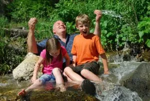 Father and kids playing in river in Smoky Mountains
