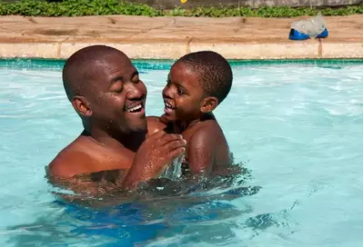 Dad_and_son_playing_in_the_water_at_our_Gatlinburg_cabins_with_pool_access